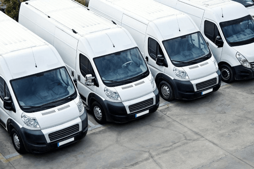 Fleet of white service vans parked in a row